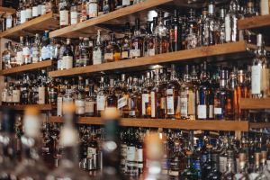 image of the back shelf at a bar with many hundreds of bottles of liquor